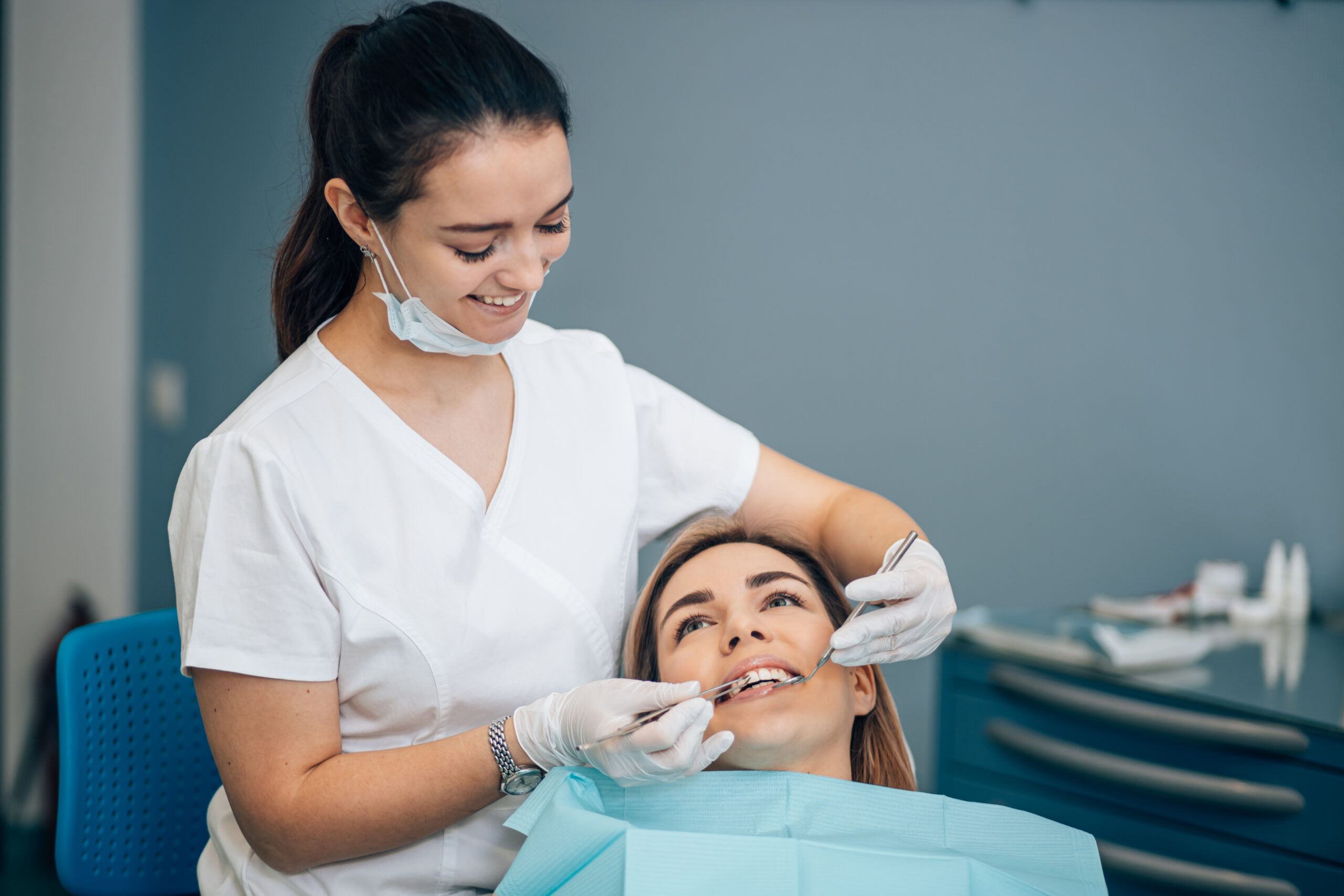 friendly dentist woman treating patient